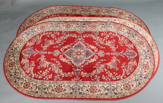 3 red ground and floral patterned machine made Persian style  rugs 77" x 48"