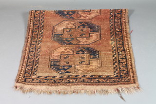 An Afghan rug with 3 elephant print octagons to the centre 40" x  36"