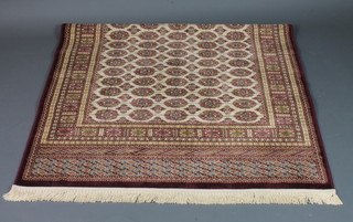 A beige ground Bokhara style Belgian cotton rug 66" x 49"