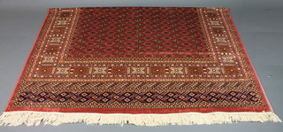 A rose ground Bokhara style Belgian cotton carpet 104" x 78"