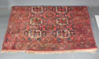 A red ground Afghan carpet with 10 octagons to the centre 109"  x 90"