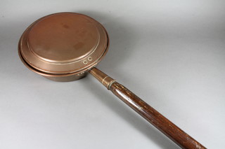 A 19th Century copper warming pan with turned elm handle