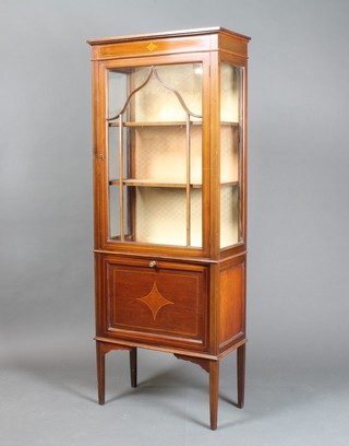 An Edwardian inlaid mahogany display cabinet, fitted shelves enclosed by astragal glazed panelled doors, the base fitted a  music drawer, raised on square tapering supports 60"h x 23.5"w  x 11"d