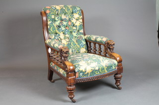 A Victorian carved walnut armchair with bobbin turned decoration and lion mask arms, raised on bulbous and fluted  supports