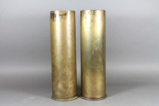 A 105mm brass shell case and 1 other