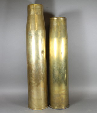 A large brass shell case marked 257 and 1 other marked 105x617