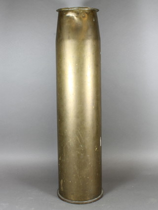 A large brass shell case, the base marked 5"MK5Gun, N5WL