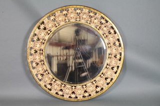 A circular bevelled plate mirror contained in a pierced giltwood frame 46"diam.