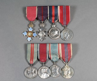 A group of 4 miniature medals comprising companion of the  Most Excellent Order of The British Empire - second type civil  division, MBE first type military division, Edward VII  Coronation medal silver issue and Elizabeth II Coronation medal,  together with a group of 4 various miniature medals comprising  George V Coronation medal, George V Jubilee medal, George VI  Coronation medal and an Elizabeth II Coronation medal   ILLUSTRATED