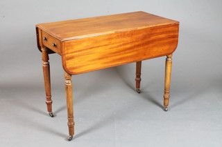 A Victorian mahogany Pembroke table fitted a frieze drawer and raised on turned supports with brass caps and casters 28"h x  35"w x 17.5"d