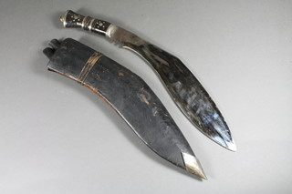 A Kukri with 12" blade, 2 skinning knives and leather scabbard