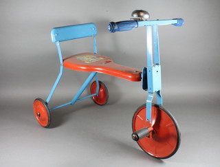 A childs blue and red metal tricycle