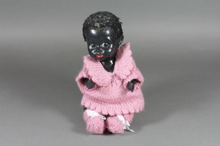 A black plastic baby doll, having jointed composite body 9"