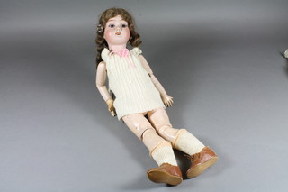 A French bisque headed doll with go to sleep eyes, the head  incised DL13, having jointed composite body 17"