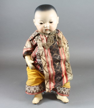 A rare Armand Marseille bisque headed Oriental baby doll,  having go to sleep eyes, closed mouth, the head impressed 353/3  1/2.K with composite body 14"h  ILLUSTRATED