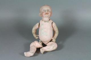 An early 20th Century Kammer & Reinhardt bisque head baby  doll with fixed eyes and mouth, the head impressed 28,KR100  with fixed composite body, approx 10"h