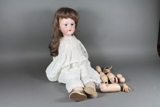 An early 20th Century Armand Marseille bisque head doll  No.3n, having blue go to sleep eyes, open mouth, the head marked A.8.M with jointed composite body 23"h