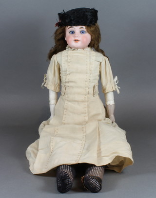 An early 20th Century Max Rader German bisque head doll,  having blue go to sleep eyes and open mouth, the head marked  R.70-3 DEP with original clothes 22"h   ILLUSTRATED