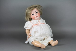 An early 20th Century Ernst Heubach bisque head doll No.300.7 having blue go to sleep eyes and open mouth, composite body  22"h