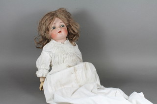A Kammer & Reinhardt/Simon & Halbig bisque head doll No.403, having go to sleep eyes, open mouth and with jointed  composite body, wearing a christening gown and under clothes  21"h