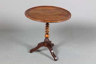 A Victorian walnut wine table having a moulded dish top raised  on a bobbin turned column support, tripod base, altered, 19.5"h  x 19"diam.