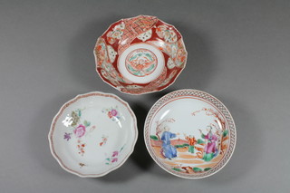 A circular Chinese red glazed porcelain saucer decorated  mythical beasts, the base with seal mark 5" and 2 other saucers
