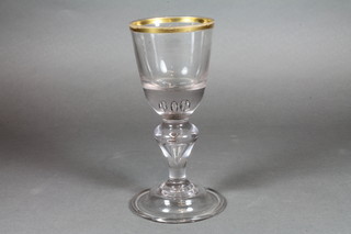 A 19th Century baluster shaped wine glass with folded foot