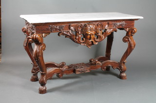 An 18th Century Italian style carved mahogany side table with  white veined marble top, the apron carved classical bust, raised  on cabriole supports with hoof feet and X framed stretcher  32.5"h x 52"w x 22"d