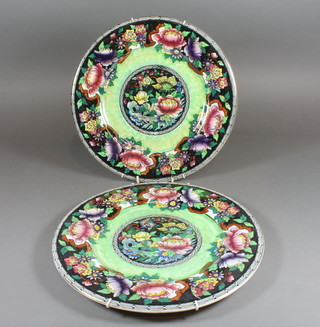 2 Malingware circular blue glazed plates with floral decoration,  base marked 6024 11"