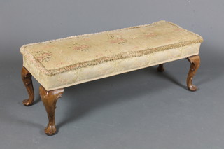 An early 20th Century Queen Anne style walnut stool, having  foliate tapestry woven upholstery raised on C scroll carved  cabriole legs, pad feet 13"h x 38"w x 14"d