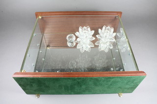 A Swarovski wall mounting display cabinet containing 2 circular Swarovski flower head candle holders 2" and a circular  paperweight