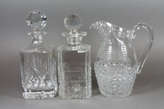 A pair of cut glass spirit decanters and stoppers and a cut glass water jug 8"