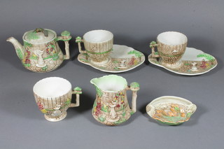 A Sylvac Arden pattern 7 piece tea service comprising teapot, 2 cups and saucers, cup and cream jug together with a Sylvac  crescent shaped vase in the form of a log