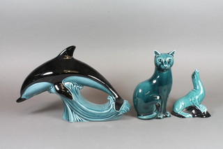 A Poole Pottery blue glazed figure of a seated Siamese cat 6", do. seal 4" and dolphin 9"