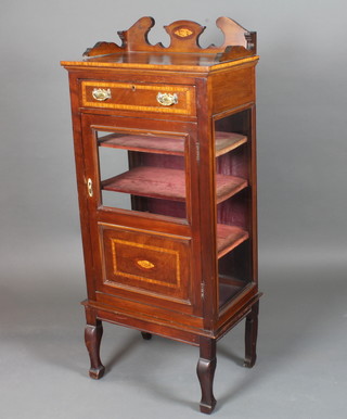 An Edwardian mahogany music cabinet, satinwood crossbanded,  with three-quarter galleried top above a single drawer with glazed  cupboard door below, raised on square cabriole legs, spade feet  51.5"h x 22"w x 14"d