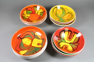 A circular Poole Pottery Atomic orange bowl 7" and a circular  Poole Pottery bowl 6.5" and 8 other bowls, some cracked 