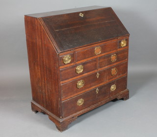 A George II oak bureau, the fall enclosing a fitted interior with well above 4 short and 2 graduated long drawers on shaped  bracket feet 39.5"h x 36"w x 20.5"d
