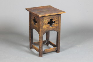 An Arts & Crafts oak occasional table with pierced frieze, raised on square legs united by stretchers 18"h x 12"w x 12"d