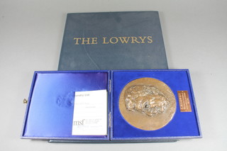 L S Lowry, a folio containing 3 limited edition prints, titles include "The Artists Mother, The Artists Father and Self  Portrait", all signed in pencil to bottom right hand margin,  161/300, 12"h x 9.5"w together with a limited edition Morris  Singer Foundry bronze medallion with a profile portrait of L S  Lowry 161/300, cased, 5"diam.
