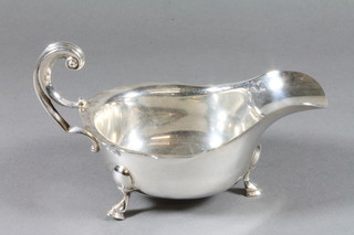 A silver sauce boat with wavy border and C scroll handle on hoof  feet, Sheffield 1921, 5 ozs