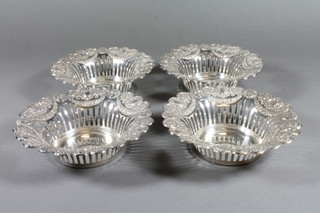 4 circular pierced and embossed silver bon bon dishes, Sheffield  1910, makers mark Cooper Brothers & Sons Ltd, 9 ozs   ILLUSTRATED