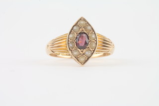A 15ct gold marquise shaped dress ring set an amethyst  surrounded by demi-pearls