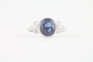 An 18ct white gold dress ring set an oval cut sapphire approx.  2.5ct and 6 diamonds to the shoulders