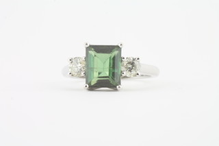 An 18ct white gold dress ring set a rectangular tourmaline  supported by 2 diamonds