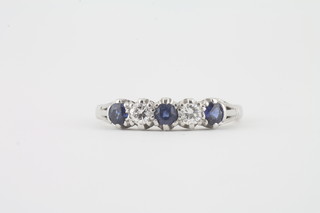 An 18ct white gold dress ring set 3 sapphires supported by 2  diamonds