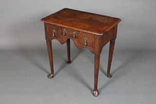 A George II oak low boy, the rectangular top with re-entrant  corners above an arrangement of 3 small drawers with shaped  apron below, raised on tapered legs and pad feet, 27.5"h x 27"w  x 18"d