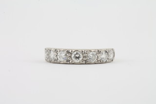 An 18ct white gold half eternity ring set diamonds