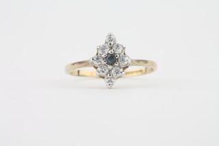A 9ct gold marquise shaped dress ring set diamond and sapphire