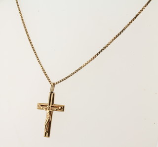 A 9ct gold crucifix hung on a 9ct gold box chain 10.4 grams