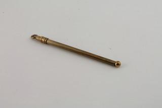 A 9ct gold swizzle stick with engine turned decoration 5.1 grams
